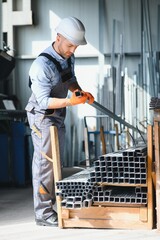 Male factory mechanics or Engineer in safety uniforms are working on metal drilling machines in...