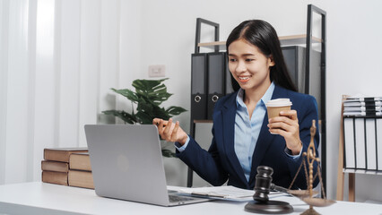 Young single female lawyer asian people in formal suit real estate working law book and contract documents, Arguments for Defense Strategy. Fight for Freedom. Supporting Evidence.