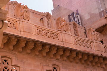 artistic design of palace wall made of red stone at day from flat angle