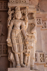 hindu god unique idol engraved art on temple wall from flat angle at morning