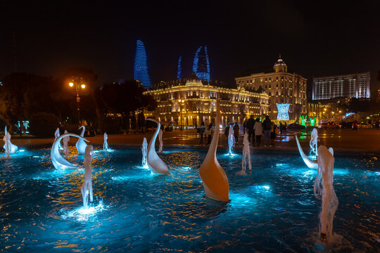 View of swans fountains  in the National Seaside Park at night in Baku city, Azerbaijan