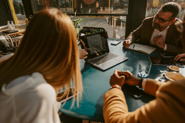 Pointing at the laptop at the table