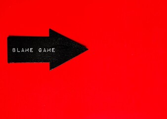 Black arrow on red background with text BLAME GAME, situation when people attempt to blame each...