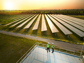 engineer men and woman inspects construction of solar cell panel. Industrial Renewable energy of...
