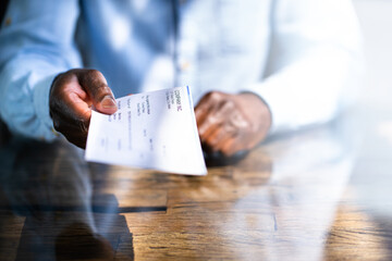 African Business Man Giving Paycheck