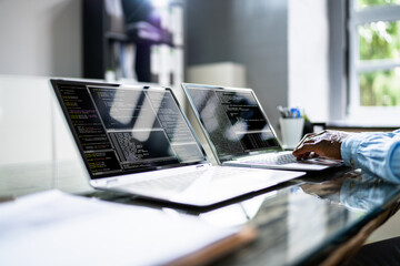 African American Coder Using Computer At Desk