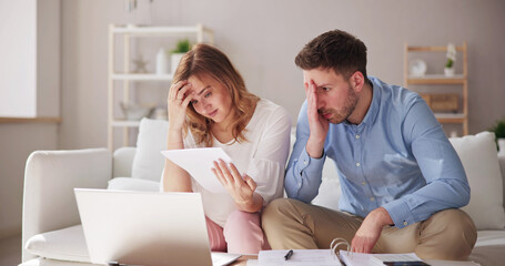 Shocked Couple Reading Bad News Letter