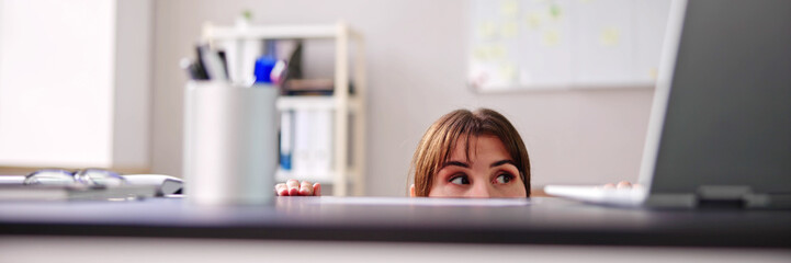 Scared Woman Hiding Behind Chair