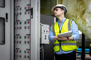 Electrical engineer working in control room. Electrical engineer man checking Power Distribution...