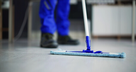 Portrait Of Happy Male Janitor Cleaning Floor
