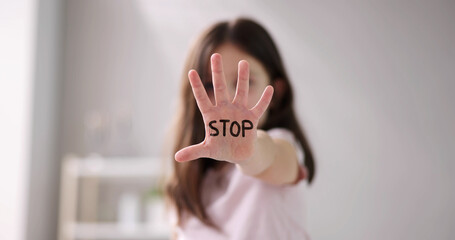 Close-up Of A Girl's Hand Showing Stop - obrazy, fototapety, plakaty