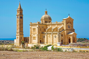 Fototapeta na wymiar Church Basilica of the National Shrine of the Blessed Virgin of Ta' Pinu at Gozo Island on a sunny hot summer day. Photo taken August 10th, 2017, Gozo, Malta.