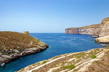 Fototapeta na wymiar Scenic view of hill with stone tower and Mediterranean Sea at Island of Gozo on a sunny hot summer day. Photo taken August 10th, 2017, Gozo, Malta.