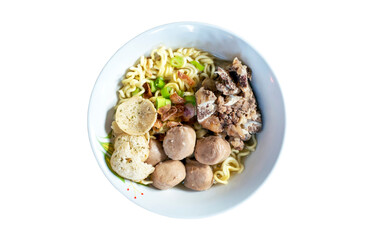 A bowl of meat ball soup with fresh vegetables isolated on white background