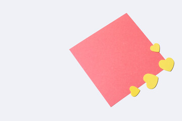 Blank paper note with small yellow hearts on white background. Love, Marriage, Valentine. Top view.