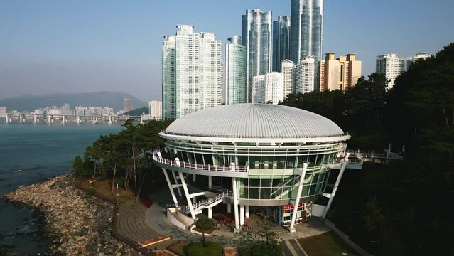 Aerial view of APEC House in Dongbaek Island and skyscrapers Busan, South Korea