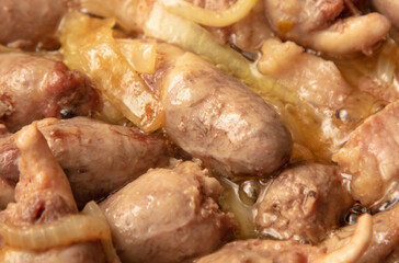 Chicken hearts are fried in a pan in oil