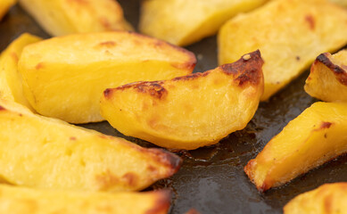Potatoes baked in the oven as a background.