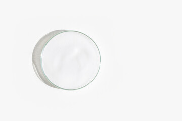 White foam in a Petri dish on a light background.