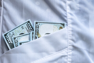 Paper money dollars in a pocket of clothes, close-up.