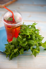 Summer mint lime refreshing cocktail mojito with ice in glass on black background copy space. Carbonated mineral water and lemon. Glass for drinks. Lemonade at the bar menu. Classic sparkle drink.