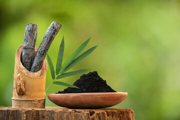 Bamboo charcoal and powder on nature background.
