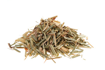 Pile of dried cut lemongrass (Cymbopogon citratus), also called citronella grass, isolated on white background