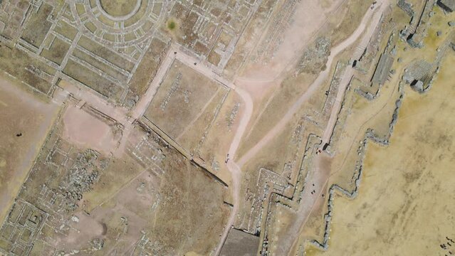 4K Aerial Drone Top Down view over Sacsayhuaman Ancient Ruins in Cusco, Peru. Traveling East