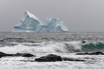 A majestic iceberg near the shore in the fishing village of Ferryland, Newfoundland and Labrador,...