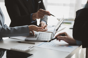 Businessman is reviewing monthly sales documents for analysis and marketing plans for more sales growth, they are the founders of young companies co-founding startups. Sales management concept.