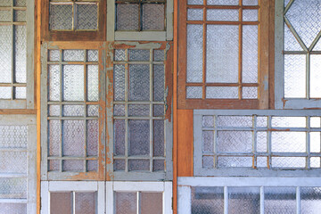 Background of Vintage interior Wall made of many the old wooden windows with patterned glass