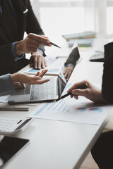 Businessman is reviewing monthly sales documents for analysis and marketing plans for more sales growth, they are the founders of young companies co-founding startups. Sales management concept.