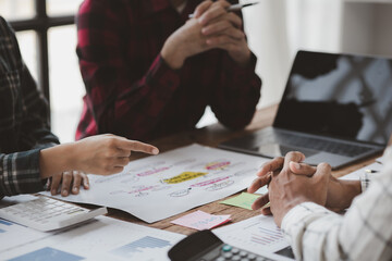 Company meeting room has businessmen and finance managers meeting together on finance topics, they are looking at information on documents and discussing together. Concept company financial management