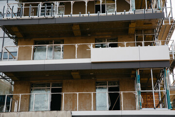 Profitable investment in modern suburban real estate under construction. Low property prices during the crisis