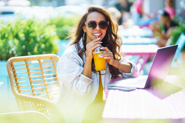 Portrait of pretty young woman sitting in cafe with phone. Сhat with friends. Freelancer, business, online, education concept.