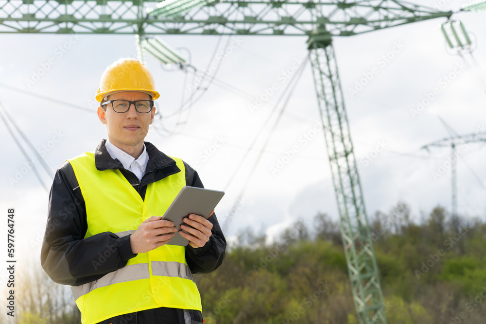 Aufkleber engineer with digital tablet on a background of power line tower
