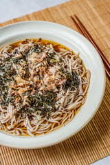 Korean food Naengmemilguksu, a winter delicacy, this buckwheat noodle dish is served in a cold chicken- or beef-based broth and topped with cold slices of beef and egg as a garnish.