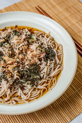 Korean food Naengmemilguksu, a winter delicacy, this buckwheat noodle dish is served in a cold chicken- or beef-based broth and topped with cold slices of beef and egg as a garnish.