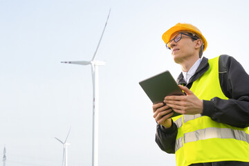 Engineer with tablet computer on a background of wind turbines	