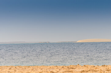 Sand dunes descending into the creek at Al-Adaid Desert in Qatar