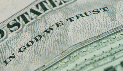 Obraz premium Macro shot image of the phrase in god we trust. Concept of financial success. Background of 5 dollar bills. Five dollars...