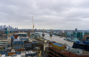 Tower Bridge in the City of London seen from the heights on a cloudy day.