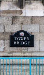 Tower Bridge sign in the City of London on a cloudy day.