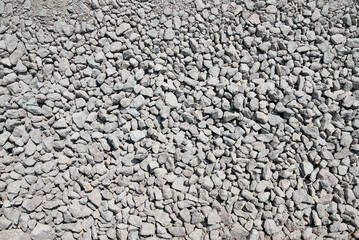 Abstract background with stones. Crushed stone texture background. Stone wall constructed by gray