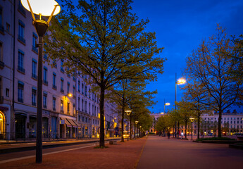 Lyon city street landscape with safety lamps lighted at dusk in France
