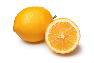 Whole and halved fresh Meyer lemon close up isolated  on white background