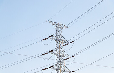 Remote photo High voltage post or transmission towers. High-voltage tower bright blue sky with bright sunlight background. Huge source of electric power. Electricity is basic utilities of each country