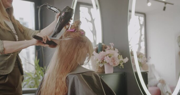 Hair drying in the hairdressing studio, trucking motion