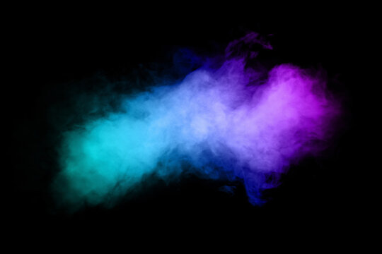 Beautiful horizontal column of smoke in the neon bright light of blue pink and orange on a black background exhaled out of the vape. Nice pattern for printing and backdrop of colored waves.