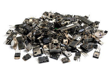 A pile of ICs, transistors, diodes that are damaged from use isolated on white background. Used...